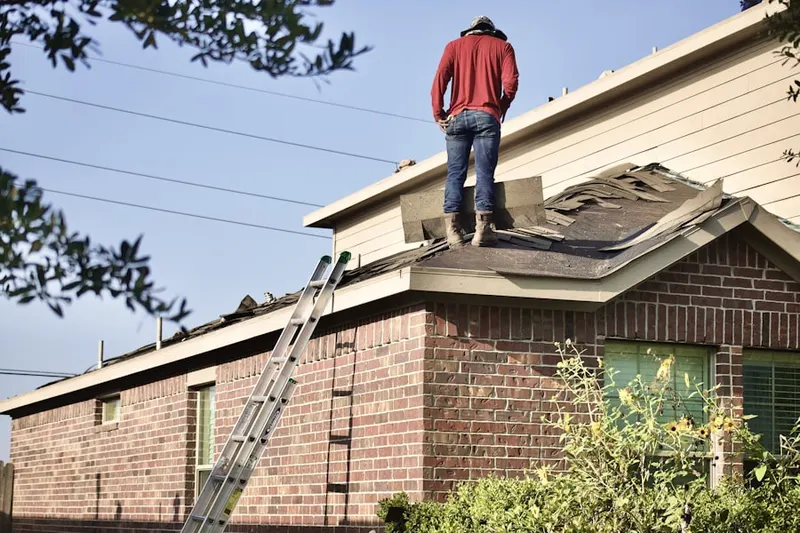 Professional roofer working on a residential roof in Harwood Heights